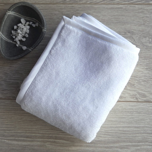 Folded white fluffy Egyptian cotton terry bath towel