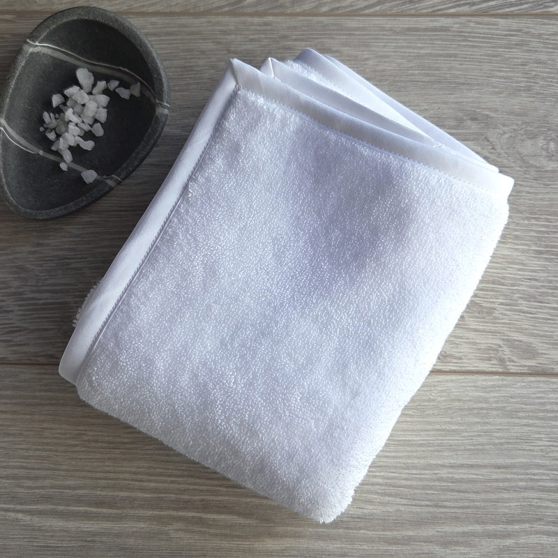 Folded white fluffy Egyptian cotton terry bath towel